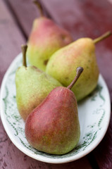 Ripe sweet pear lying on a white plate