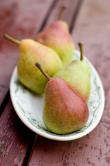 Ripe sweet pear lying on a white plate