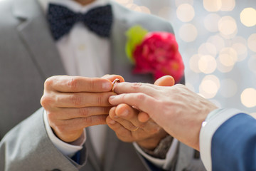 close up of male gay couple hands and wedding ring