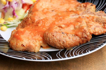 Steaks, pork, french fries with salad.