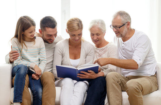 happy family with book or photo album at home