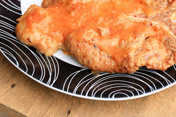 Steaks, pork, french fries with salad.