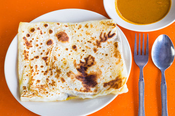 Roti Prata or Roti Canai, Indian bread served with curry © ThamKC