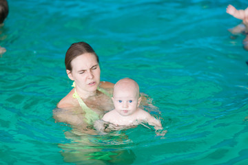 Mother with baby in swimming pool
