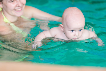 Fototapeta na wymiar Mother with baby in swimming pool