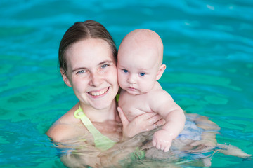 Mother with baby in swimming pool