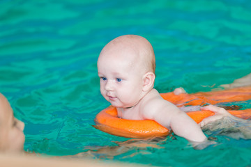 Mother with baby in swimming pool