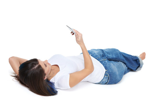 Woman lying on her back and using phone