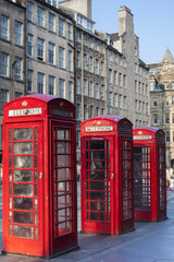 Fototapeta na wymiar Old red telephone booths Royal mile street in Edinburgh