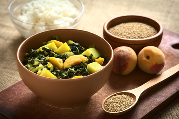 Bowl of spinach, peach and potato curry dish