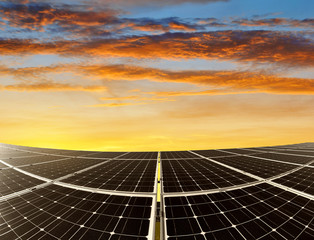 Solar energy panels against sunset sky. Green energy.
