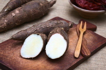 Cut manioc halves (lat. Manihot esculenta) on wooden board
