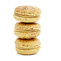 close up of colorful macarons over white background