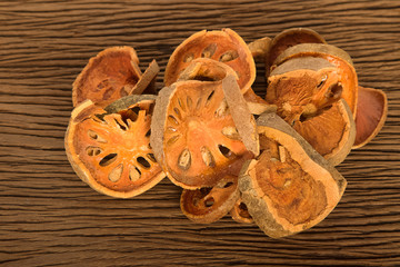 Fototapeta premium Piece of dried balefruit on wooden board