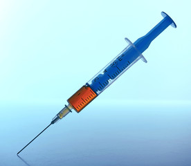 Medical syringe on blue background