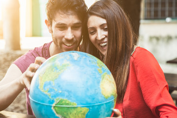 Young couple looks the world map