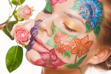 Close up portrait of woman model with hand drawing flowers on