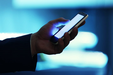 Male hand touching screen phone close-up