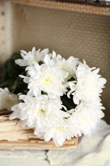Old wooden suitcase with old books and flowers