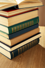 Old books on wooden table, closeup