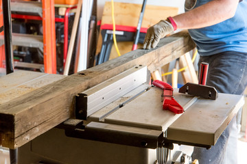 man cutting 4x4 on table saw