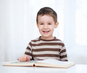 Little boy is reading a book