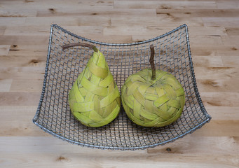 Fruits made from bast in the silver basket