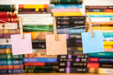 clear post it on string with pegs with books blurred background