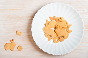 Easter cookies in the shape rabbits and  butterflies on a plate