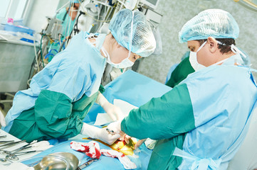 surgeons perfoming abdominal cesarean section