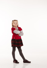 little girl in red dress posing standing in studio