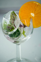 A glass with frosted leaves and orange