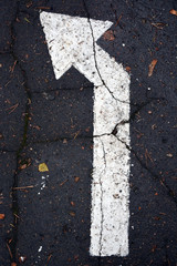 Fototapeta na wymiar White arrow on traffic surface as a background
