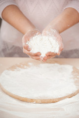 Close up photo of flour in female hands