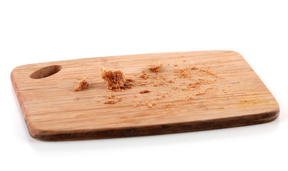 Bread crumbs on cutting board isolated on white