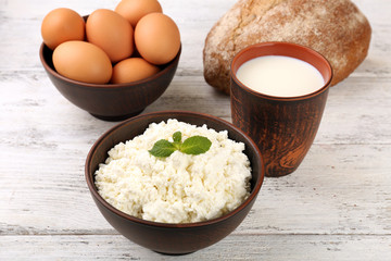 Tasty dairy products with bread on table close up