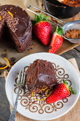 slice of homemade chocolate cake serving on retro plate