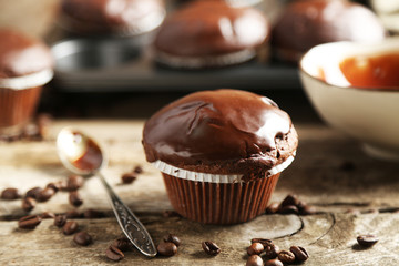 Tasty homemade chocolate muffins on wooden table
