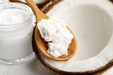 Coconut with coconut oil and jar of cosmetic cream