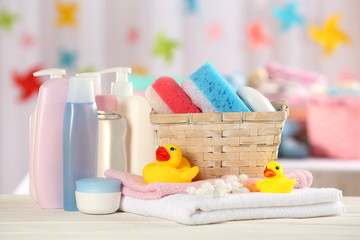 Baby accessories for bathing on table on light background