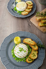 Grilled camembert with herbs, baquettes