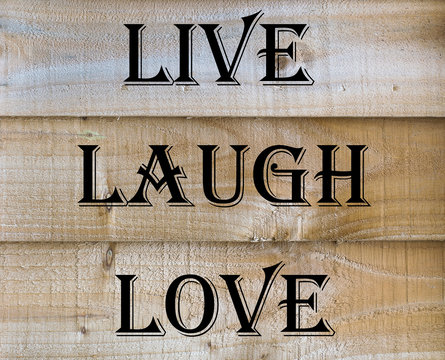 Live Laugh Love quote on a wooden background