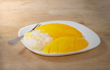Sticky Rice with Mango on wood background