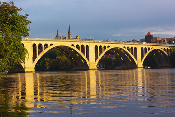 Fototapeta na wymiar Key Bridge reflections in waters of Potomac River, Washington DC