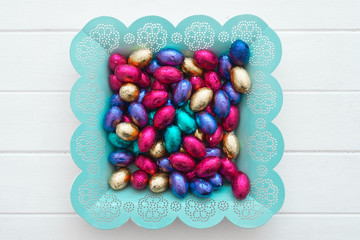 mini colourful chocolate easter eggs in a pretty blue dish