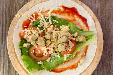 Tortilla with chicken, tomatoes,  salad