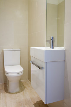 Angled view of newly renovated bathroom toilet and basin