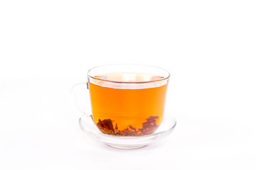 isolated transparent cup of brown tea 