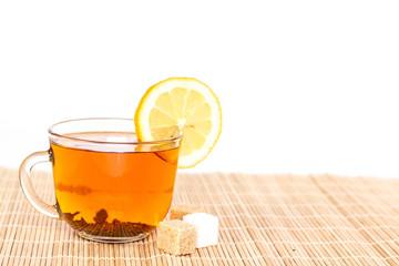 transparent cup of lemon tea on wooden background