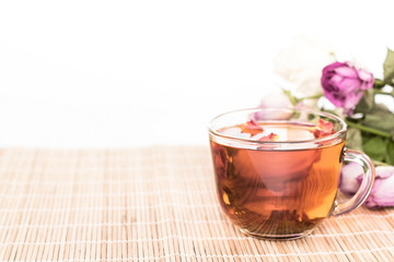 cup of tea and  wilted bouquet on wooden background